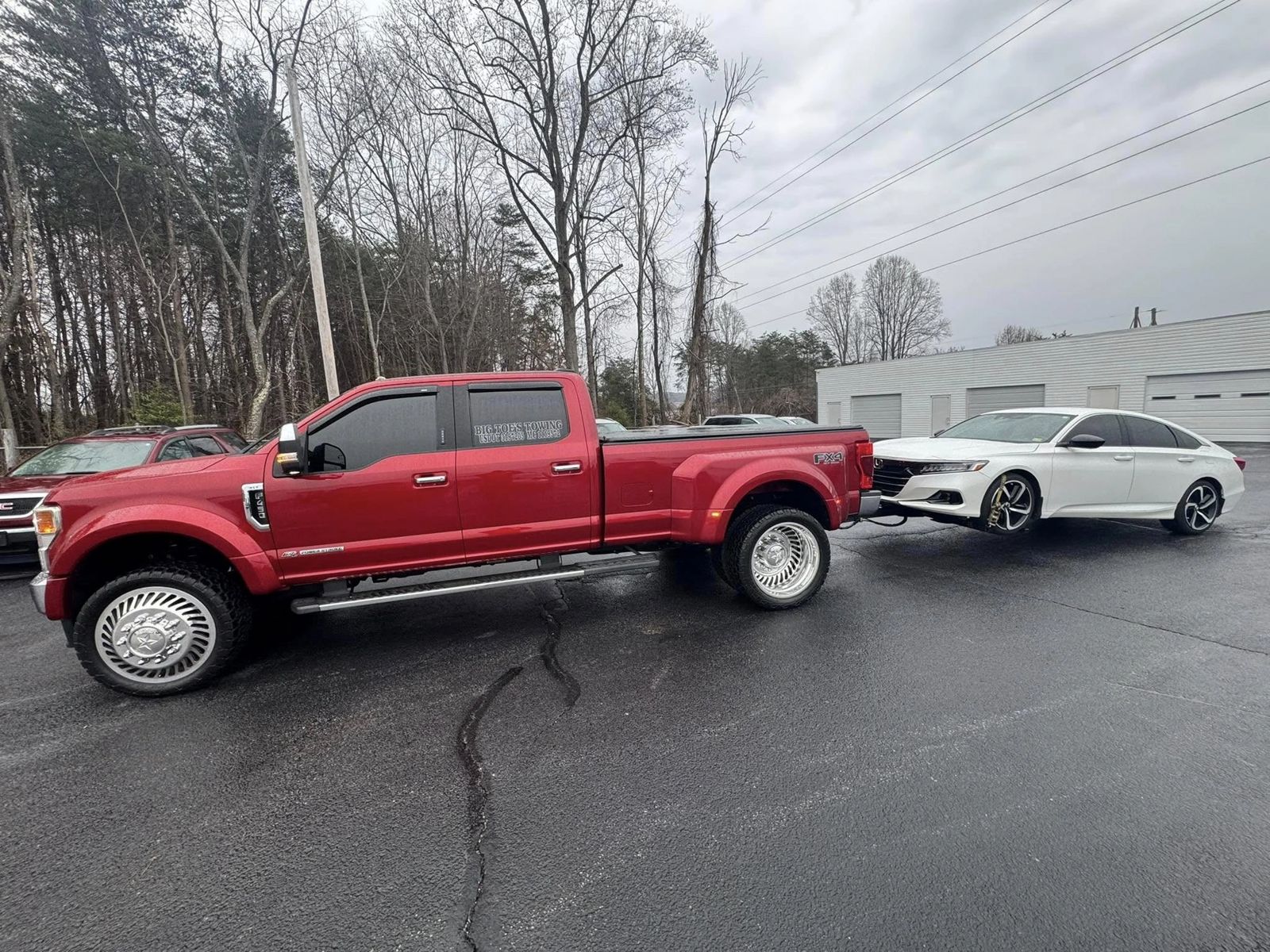 Red Big Toe's dually towing a white Honda Accord